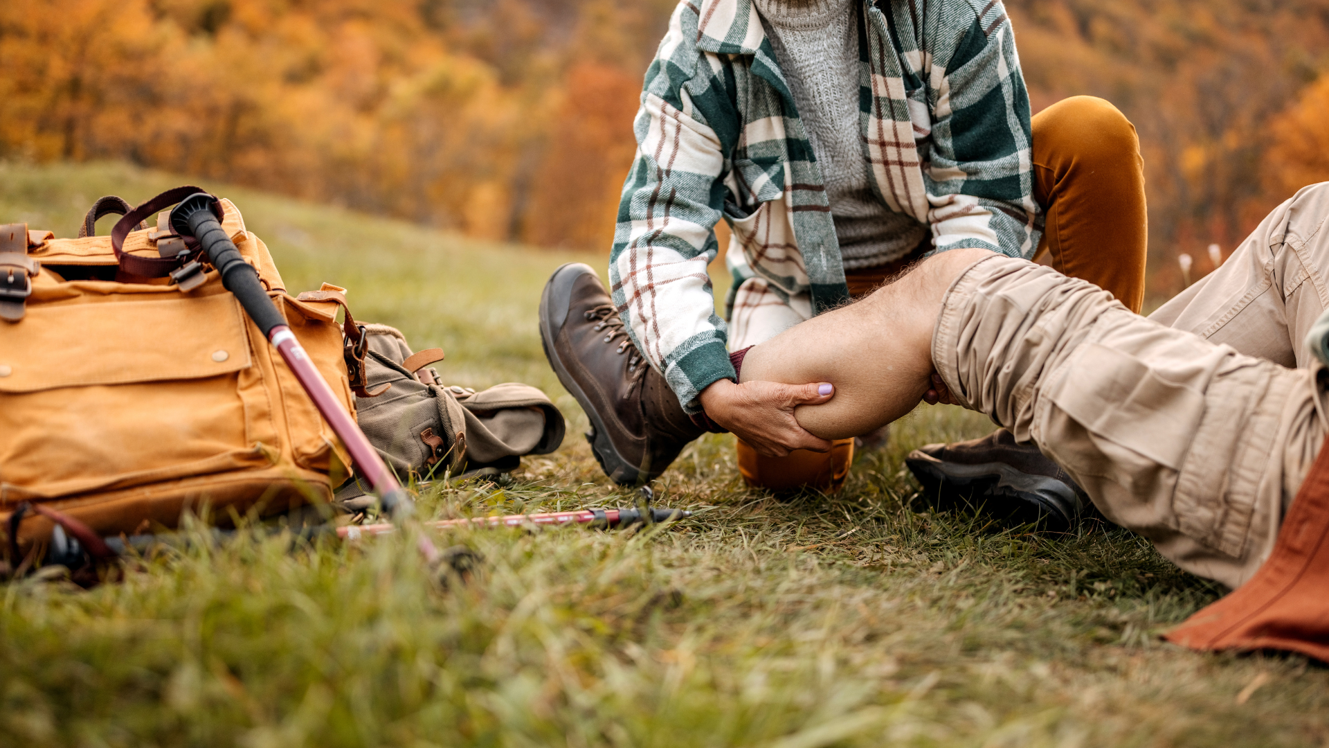 Man giving first aid to leg