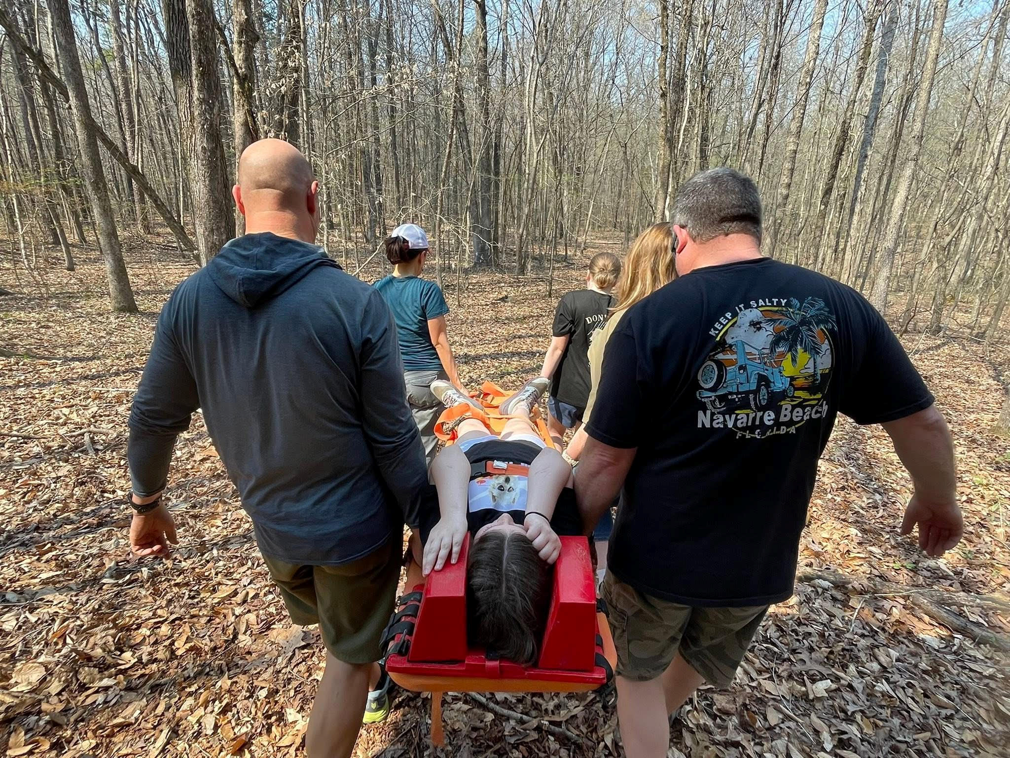 People Carrying Person on Stretcher