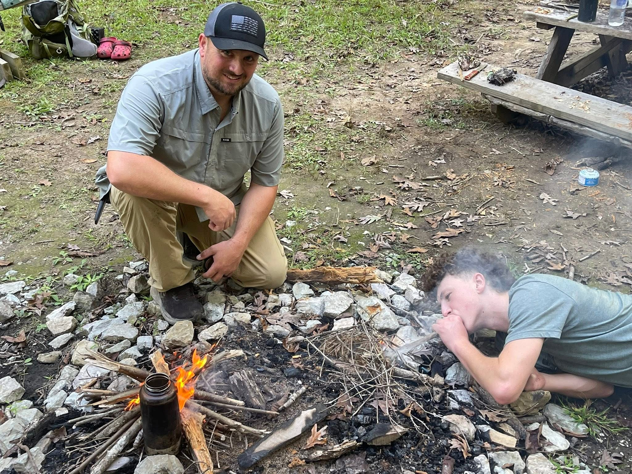 People building campfire